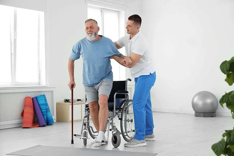 Elderly man receiving Ayurvedic neuro rehabilitation therapy at Kalarickal Ayurveda Hospital